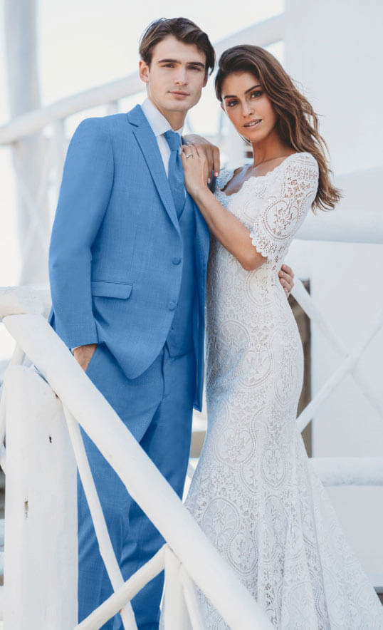 Сouple wearing a white gown and a blue suit