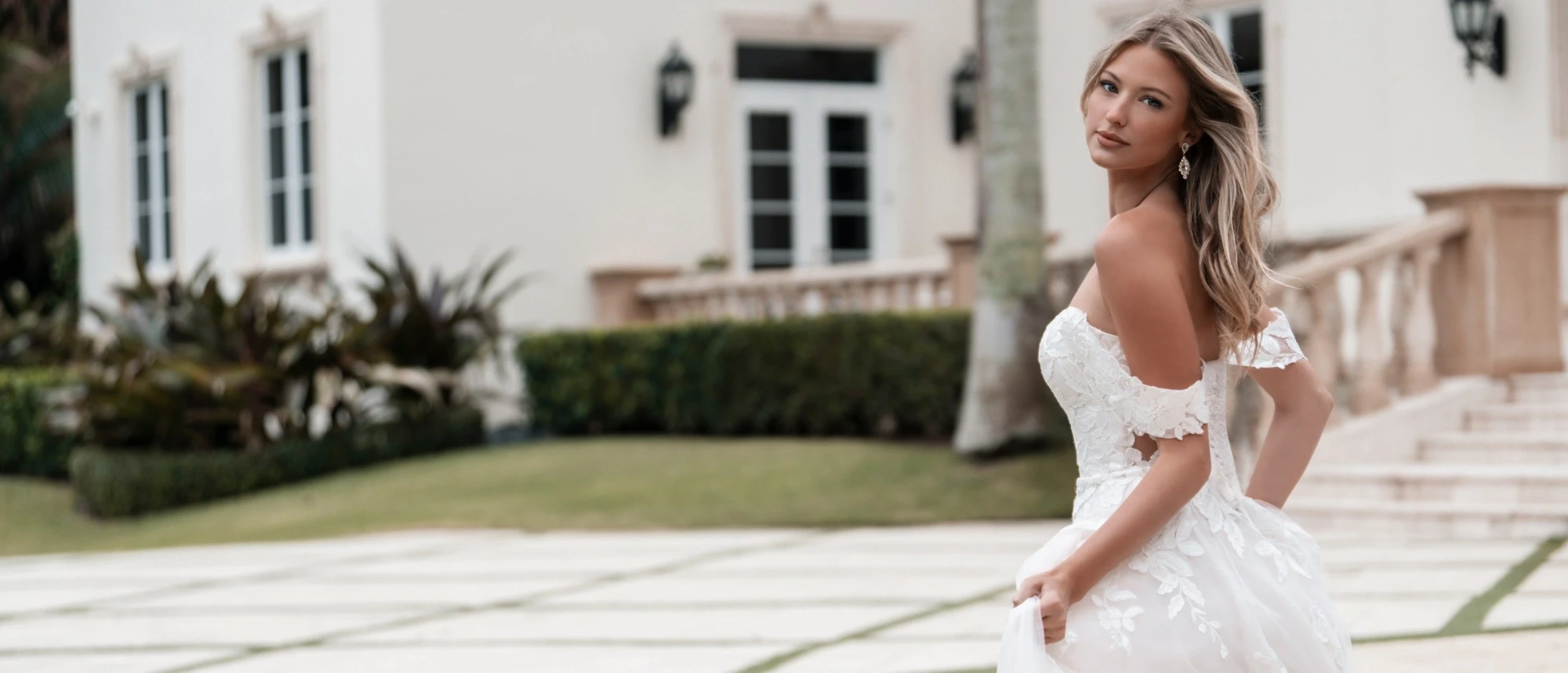 Model wearing a white gown