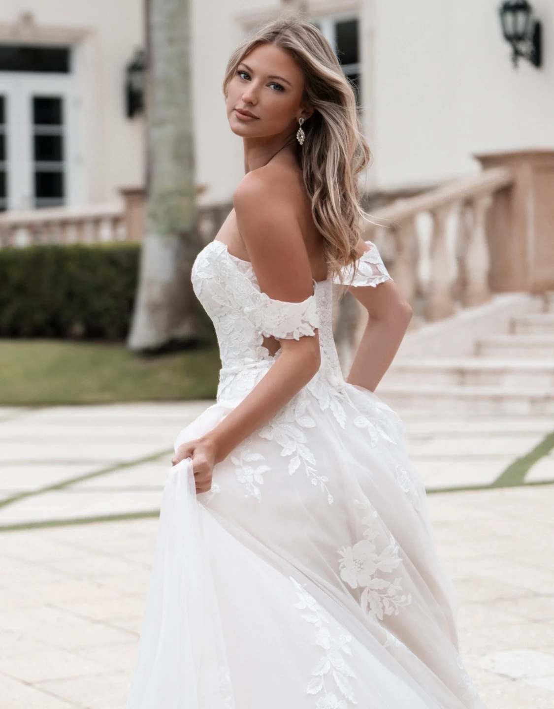 Model wearing a white gown. Mobile image