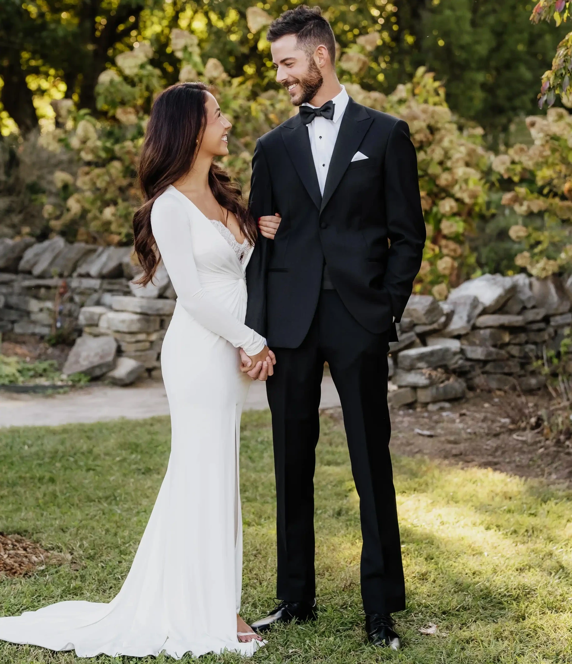 Сouple wearing a white gown and a black suit