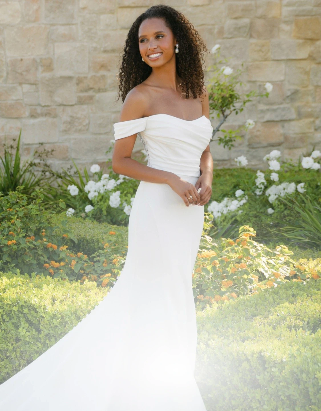 Model wearing a white gown. Mobile image